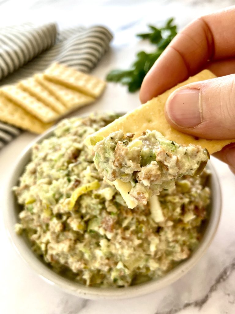 cracker dipped in vegan chicken salad